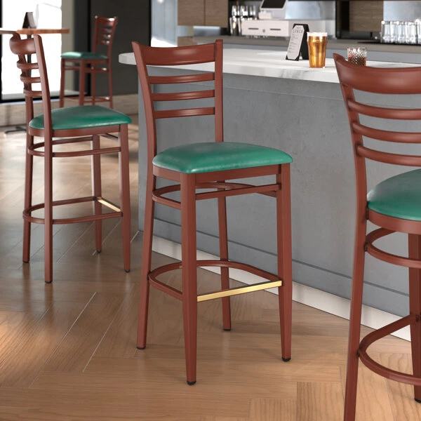 Best deal 😍 LT&S Spartan Series Lancaster Table & Seating Spartan Series Bar Height Metal Ladder Back Chair With Mahogany Wood Grain Finish And Green Vinyl Seat 🤩