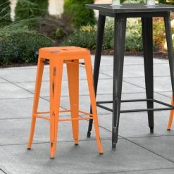 Budget 🔔 LT&S Alloy Series Lancaster Table & Seating Alloy Series Distressed Orange Stackable Metal Indoor / Outdoor Industrial Barstool With Drain Hole Seat ⌛